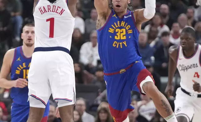 Denver Nuggets forward Aaron Gordon, right, passes the ball as Los Angeles Clippers guard James Harden defends during the first half of an NBA basketball game, Sunday, Dec. 1, 2024, in Inglewood, Calif. (AP Photo/Mark J. Terrill)