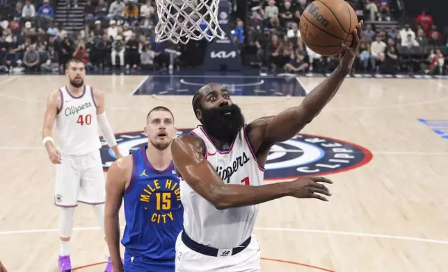 Los Angeles Clippers guard James Harden, right, shoots as Denver Nuggets center Nikola Jokic defends during the first half of an NBA basketball game, Sunday, Dec. 1, 2024, in Inglewood, Calif. (AP Photo/Mark J. Terrill)