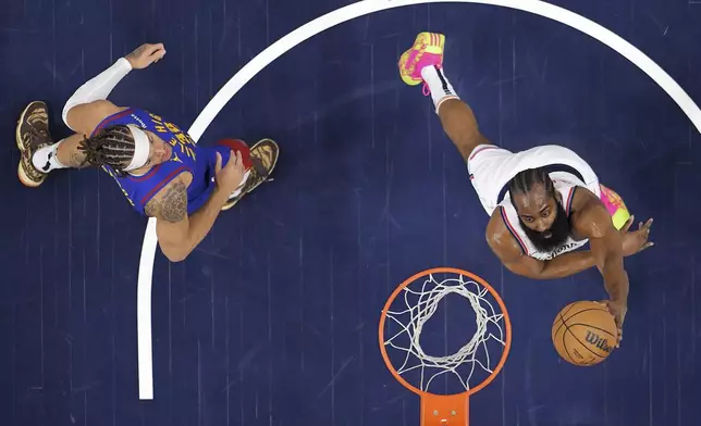 Los Angeles Clippers guard James Harden, right, shoots as Denver Nuggets forward Aaron Gordon defends during the first half of an NBA basketball game, Sunday, Dec. 1, 2024, in Inglewood, Calif. (AP Photo/Mark J. Terrill)