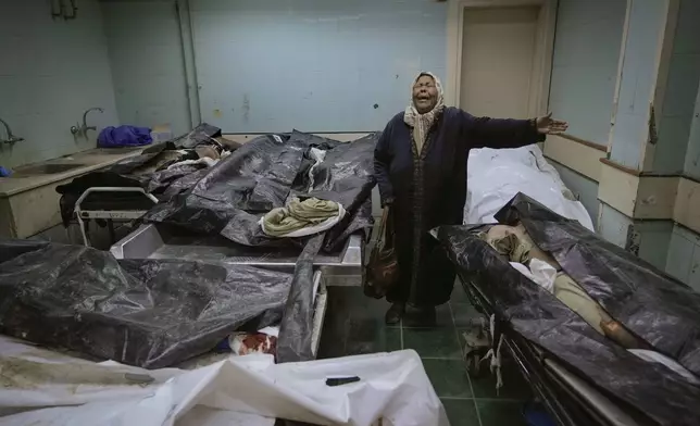 Hilala Meryeh, a 64-year-old Palestinian mother of four, weeps in the middle of the dingy identification room after finding her son's body at the Al-Mojtahed Hospital morgue in Damascus, Syria, on Wednesday, Dec. 11, 2024. Many are flocking to morgues, hoping to identify loved ones who were either killed or imprisoned under President Bashar Assad's government, which collapsed over the weekend. (AP Photo/Hussein Malla)