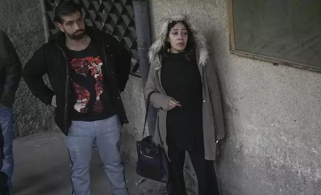 Mourners stand outside the morgue at the Al-Mojtahed Hospital in Damascus, Syria, Wednesday, Dec. 11, 2024. Many are flocking to morgues, hoping to identify loved ones who were either killed or imprisoned under President Bashar Assad's government, which collapsed over the weekend. (AP Photo/Hussein Malla)