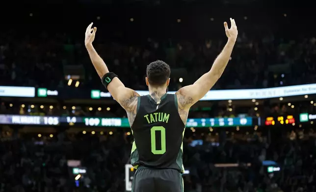 Boston Celtics forward Jayson Tatum (0) celebrates as his team defeats the Milwaukee Bucks in an NBA basketball game, Friday, Dec. 6, 2024, in Boston. (AP Photo/Mary Schwalm)