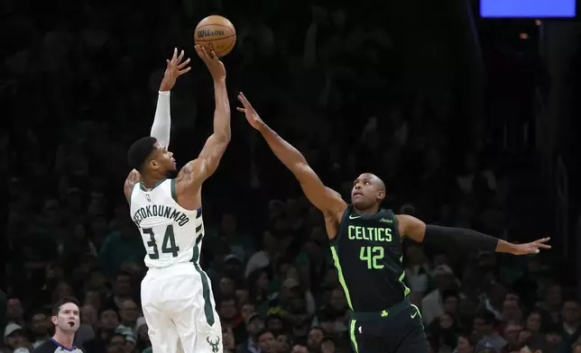 Milwaukee Bucks forward Giannis Antetokounmpo (34) shoots over Boston Celtics center Al Horford (42) during the first half of an NBA basketball game, Friday, Dec. 6, 2024, in Boston. (AP Photo/Mary Schwalm)