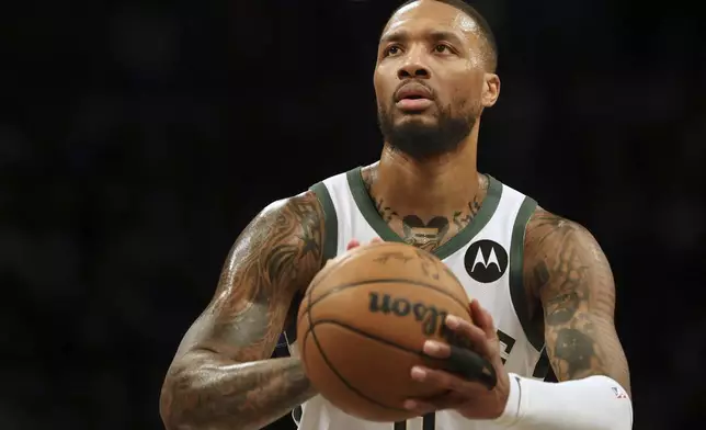 Milwaukee Bucks' Damian Lillard prepares to shoot during the first half of an NBA basketball game against the Brooklyn Nets, Sunday, Dec. 8, 2024, in New York. (AP Photo/Heather Khalifa)