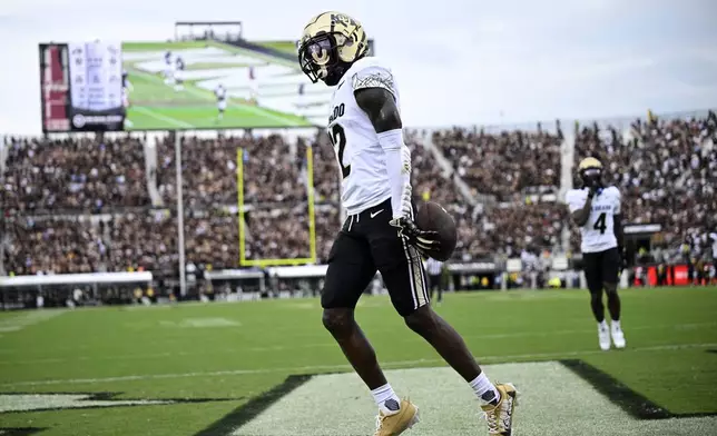 FILE - Colorado wide receiver Travis Hunter (12) celebrates his touchdown catch during the first half of an NCAA college football game against Central Florida, Saturday, Sept. 28, 2024, in Orlando, Fla. (AP Photo/Phelan M. Ebenhack, File)