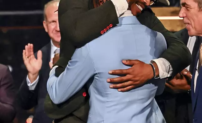 Colorado’s Travis Hunter, in blue, is embraced by 2010 Heisman winner Cam Newtown after winning the Heisman Trophy as the outstanding player in college football, Saturday, Dec. 14, 2024, in New York.(Todd Van Emst/Heisman Trust via AP, Pool)