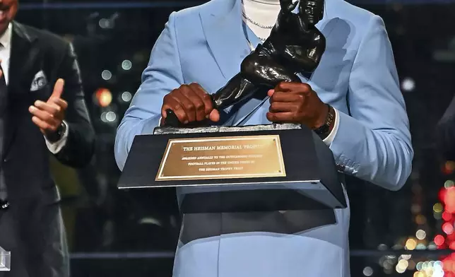 Colorado’s Travis Hunter reacts after winning the Heisman Trophy as the outstanding player in college football, Saturday, Dec. 14, 2024, in New York. (Todd Van Emst/Heisman Trust via AP, Pool)