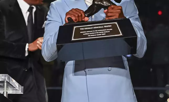 Colorado’s Travis Hunter reacts after winning the Heisman Trophy as the outstanding player in college football, Saturday, Dec. 14, 2024, in New York. (Todd Van Emst/Heisman Trust via AP, Pool)