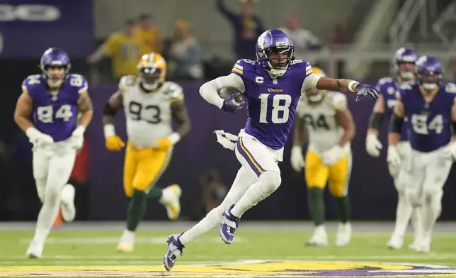 Minnesota Vikings' Justin Jefferson catches a pass for a first down during the second half of an NFL football game against the Green Bay Packers Sunday, Dec. 29, 2024, in Minneapolis. (AP Photo/Abbie Parr)