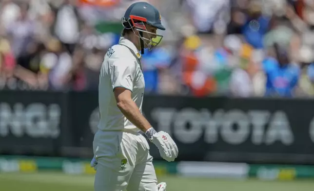 /Australia's Mitchell Marsh walks off the field after losing his wicket during play on the day four of the fourth cricket test between Australia and India at the Melbourne Cricket Ground, Melbourne, Australia, Sunday, Dec. 29, 2024. (AP Photo/Asanka Brendon Ratnayake)