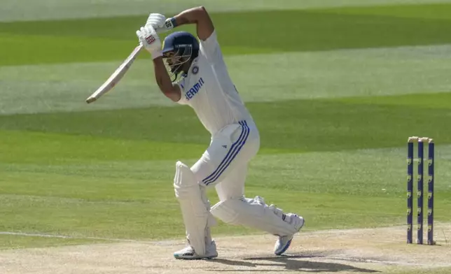 India's Nitish Kumar Reddy plays a shot during play on the day four of the fourth cricket test between Australia and India at the Melbourne Cricket Ground, Melbourne, Australia, Sunday, Dec. 29, 2024. (AP Photo/Asanka Brendon Ratnayake)