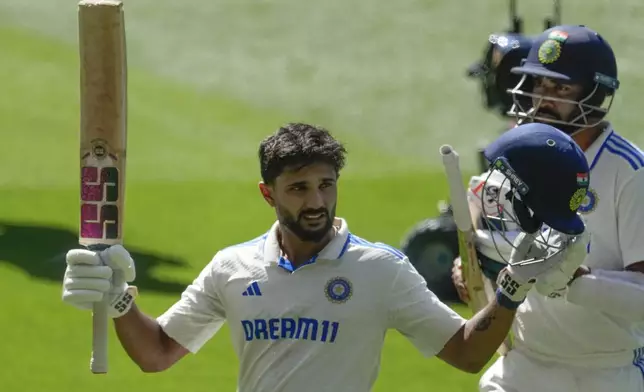 India's Nitish Kumar Reddy acknowledged the crowd as he walks off the field after losing his wicket during play on the day four of the fourth cricket test between Australia and India at the Melbourne Cricket Ground, Melbourne, Australia, Sunday, Dec. 29, 2024. (AP Photo/Asanka Brendon Ratnayake)