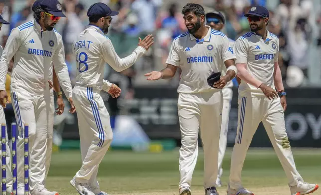 India's Jasprit Bumrah, second right without cap, celebrates with teammates after the dismissal of Australia's Alex Carey during play on the day four of the fourth cricket test between Australia and India at the Melbourne Cricket Ground, Melbourne, Australia, Sunday, Dec. 29, 2024. (AP Photo/Asanka Brendon Ratnayake)