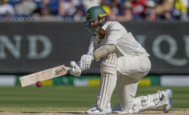 Australia's Nathan Lyon plays a shot during play on the day four of the fourth cricket test between Australia and India at the Melbourne Cricket Ground, Melbourne, Australia, Sunday, Dec. 29, 2024. (AP Photo/Asanka Brendon Ratnayake)