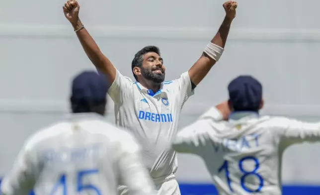 India's Jasprit Bumrah celebrates with teammates after the wicket of Australia's Mitchell Marsh during play on the day four of the fourth cricket test between Australia and India at the Melbourne Cricket Ground, Melbourne, Australia, Sunday, Dec. 29, 2024. (AP Photo/Asanka Brendon Ratnayake)