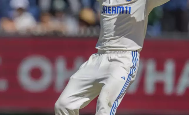 India's Virat Kohli celebrates the wicket of Australia's Mitchell Starc during play on the day four of the fourth cricket test between Australia and India at the Melbourne Cricket Ground, Melbourne, Australia, Sunday, Dec. 29, 2024. (AP Photo/Asanka Brendon Ratnayake)