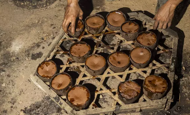 Amal Susanto makes palm sugar at his house on Kabaena Island, Southeast Sulawesi, Indonesia, Friday, Friday, Nov. 15, 2024. (AP Photo/Yusuf Wahil)