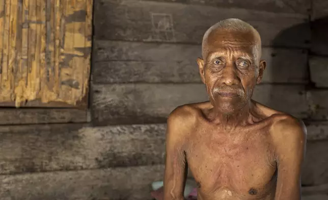 Ilyas, 70, who has been complaining of itchy skin rashes, sits for a photograph at his house on Kabaena Island near nickel mining activities in South Sulawesi, Indonesia, Friday, Nov. 15, 2024. (AP Photo/Yusuf Wahil)