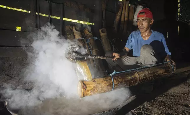 Amal Susanto makes palm sugar at his house on Kabaena Island, Southeast Sulawesi, Indonesia, Friday, Friday, Nov. 15, 2024. (AP Photo/Yusuf Wahil)