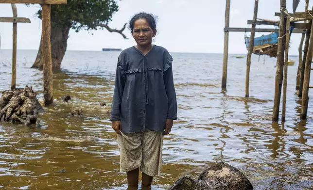 Nina, 33, a member of Bajau Tribe, poses for a photograph on Kabaena Island, in South Sulawesi, Indonesia, Friday, Nov. 15, 2024. (AP Photo/Yusuf Wahil)