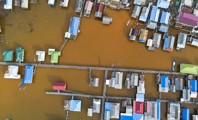 Murky brown water is visible near nickel mining activities that surround Baliara village on Kabaena Island, Southeast Sulawesi, Friday, Nov. 15, 2024. (AP Photo/Yusuf Wahid)