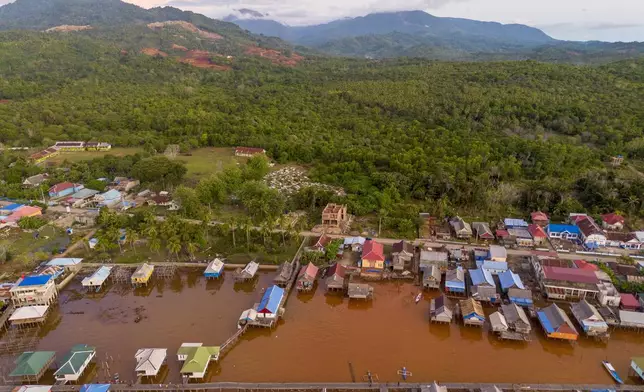 Murky brown water is visible near nickel mining activities that surround Baliara village on Kabaena Island, Southeast Sulawesi, Friday, Nov. 15, 2024. (AP Photo/Yusuf Wahid)