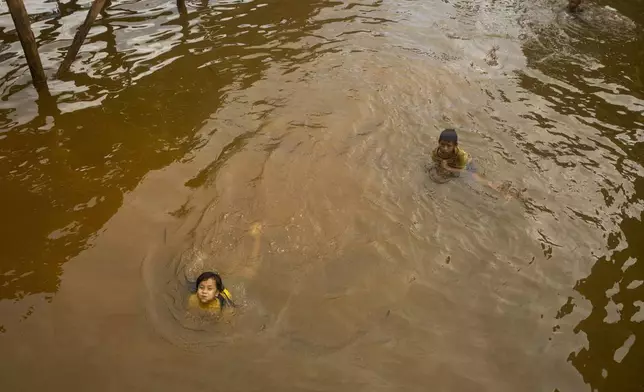 Children play in the water on Kabaena Island in South Sulawesi, Indonesia, Friday, Nov. 15, 2024. (AP Photo/Yusuf Wahil)