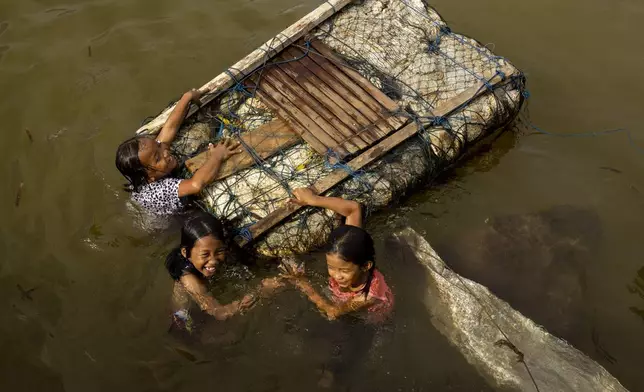 Children play in the water on Kabaena Island in South Sulawesi, Indonesia, Friday, Nov. 15, 2024. (AP Photo/Yusuf Wahil)