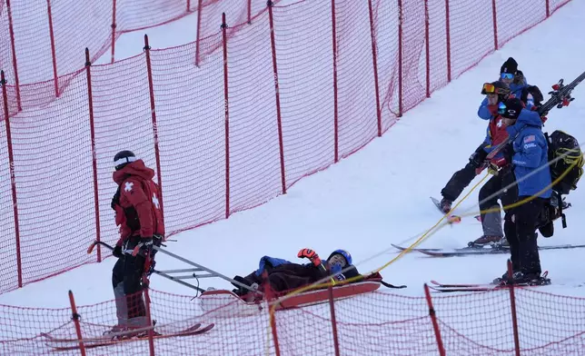 Mikaela Shiffrin, of the United States, is taken down the mountain on a sled by ski patrol after crashing during the second run of a women's World Cup giant slalom skiing race, Saturday, Nov. 30, 2024, in Killington, Vt. (AP Photo/Robert F. Bukaty)