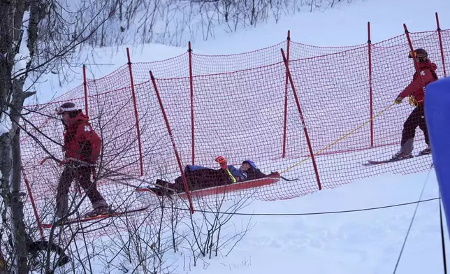 Mikaela Shiffrin, of the United States, is taken down the mountain on a sled by ski patrol after crashing during the second run of a women's World Cup giant slalom skiing race, Saturday, Nov. 30, 2024, in Killington, Vt. (AP Photo/Robert F. Bukaty)