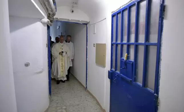 FILE - Pope Francis walks inside the Paliano detention center, south of Rome, Thursday, April 13, 2017. (L'Osservatore Romano/Pool Photo via AP, File)