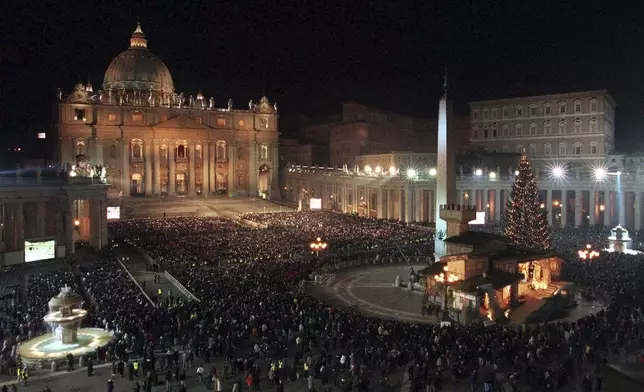 FILE - A view of St. Peter' s Square crowded with faithful watching on giant screens Pope John Paul II opening the bronze Holy Door of St. Peter's Basilica at the Vatican, late Friday night, Dec. 24, 1999, leading his church into Christianity's third millennium. (AP Photo/Federico Sambucetti, File)