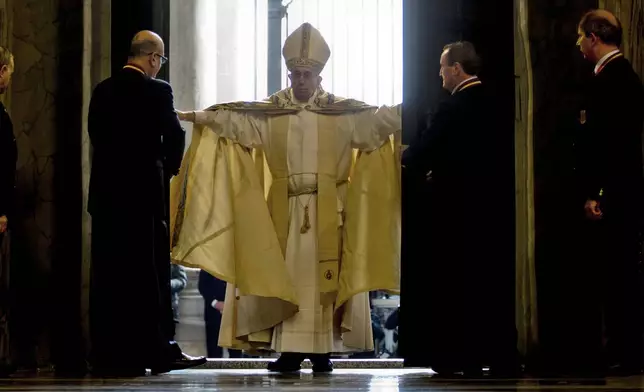 FILE - Pope Francis opens the Holy Door of St. Peter's Basilica at the Vatican, Tuesday, Dec. 8, 2015. (AP Photo/Andrew Medichini, File)