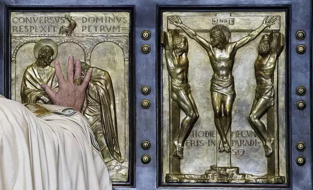 FILE - Pope Francis pushes open the Holy Door of St. Peter's Basilica, formally launching the Holy Year of Mercy, at the Vatican, Tuesday, Dec. 8, 2015. (AP Photo/Gregorio Borgia, File)