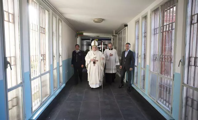 FILE - In this April 2, 2015 pool photo Pope Francis, center, holds the pastoral staff as he arrives for a Holy Thursday homily in the Rebibbia prison chapel in Rome. (AP Photo/L'Osservatore Romano, Pool, File)