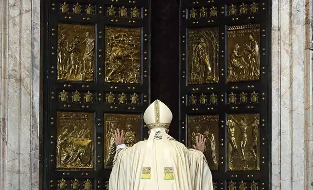 FILE - Pope Francis pushes open the Holy Door of St. Peter's Basilica, formally launching the Holy Year of Mercy, at the Vatican, Tuesday, Dec. 8, 2015. (AP Photo/Gregorio Borgia, File)