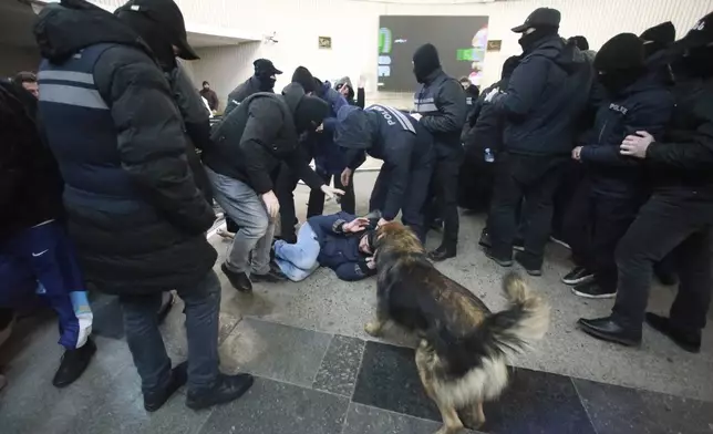 Police officers detain a demonstrator at a subway station during a rally against the government's decision to suspend negotiations on joining the European Union for four years in Tbilisi, Georgia, Monday, Dec. 2, 2024. (AP Photo/Zurab Tsertsvadze)