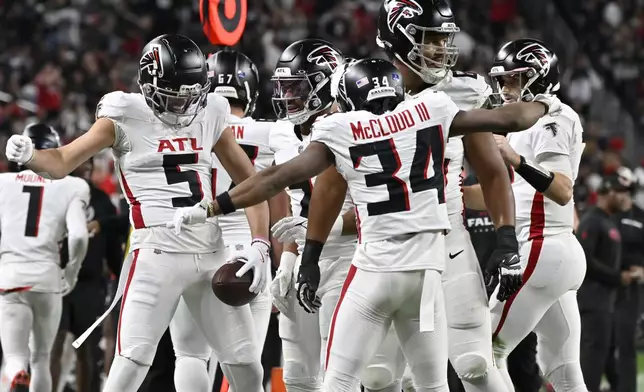 Atlanta Falcons wide receiver Drake London (5) celebrates his touchdown against the Las Vegas Raiders with teammates during the first half of an NFL football game, Monday, Dec. 16, 2024, in Las Vegas. (AP Photo/David Becker)