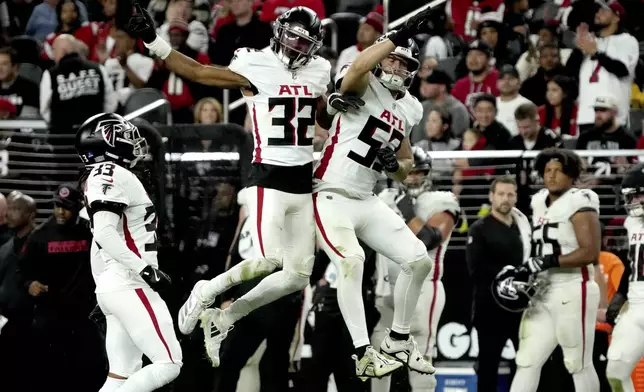 Atlanta Falcons cornerback Kevin King (32) and linebacker Nate Landman (53) celebrate a blocked point after attempt against the Las Vegas Raiders during the second half of an NFL football game, Monday, Dec. 16, 2024, in Las Vegas. (AP Photo/Rick Scuteri)