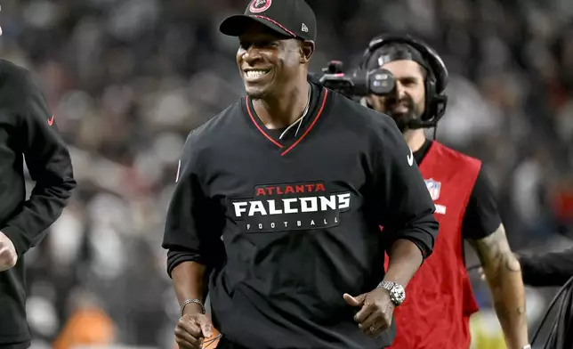 Atlanta Falcons head coach Raheem Morris smiles during the first half of an NFL football game against the Las Vegas Raiders, Monday, Dec. 16, 2024, in Las Vegas. (AP Photo/David Becker)