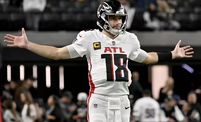 Atlanta Falcons quarterback Kirk Cousins (18) stretches prior to an NFL football game against the Las Vegas Raiders, Monday, Dec. 16, 2024, in Las Vegas. (AP Photo/David Becker)