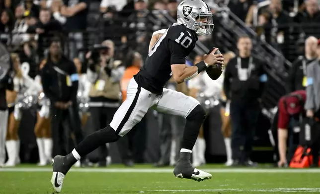 Las Vegas Raiders quarterback Desmond Ridder (10) runs the ball against the Atlanta Falcons during the first half of an NFL football game, Monday, Dec. 16, 2024, in Las Vegas. (AP Photo/David Becker)