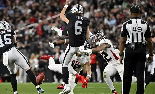 Atlanta Falcons' KhaDarel Hodge (12) blocks the punt of Las Vegas Raiders punter AJ Cole (6) during the second half of an NFL football game, Monday, Dec. 16, 2024, in Las Vegas. (AP Photo/David Becker)