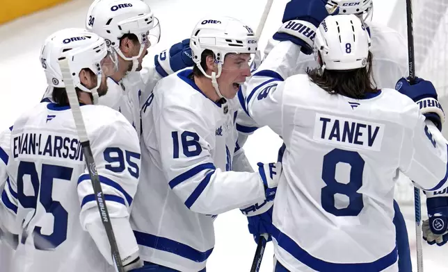 Toronto Maple Leafs' Mitch Marner (16) celebrates after scoring during the first period of an NHL hockey game against the Pittsburgh Penguins, Saturday, Dec. 7, 2024, in Pittsburgh. (AP Photo/Gene J. Puskar)
