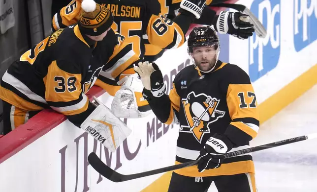 Pittsburgh Penguins' Bryan Rust (17) returns to the bench after scoring during the first period of an NHL hockey game against the Toronto Maple Leafs, Saturday, Dec. 7, 2024, in Pittsburgh. (AP Photo/Gene J. Puskar)