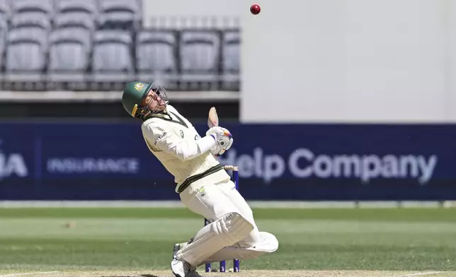 Australia's Alex Carey ducks to avoid a bouncer from India's captain Jasprit Bumrah on the fourth day of the first cricket test between Australia and India in Perth, Australia, Monday, Nov. 25, 2024. (AP Photo/Trevor Collens)