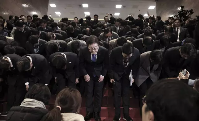 South Korea's main opposition Democratic Party leader Lee Jae-myung, bottom center, and his party members bow at the National Assembly in Seoul, South Korea, after South Korea’s parliament voted to impeach President Yoon Suk Yeol Saturday, Dec. 14, 2024. (Kim Ju-hyung/Yonhap via AP)