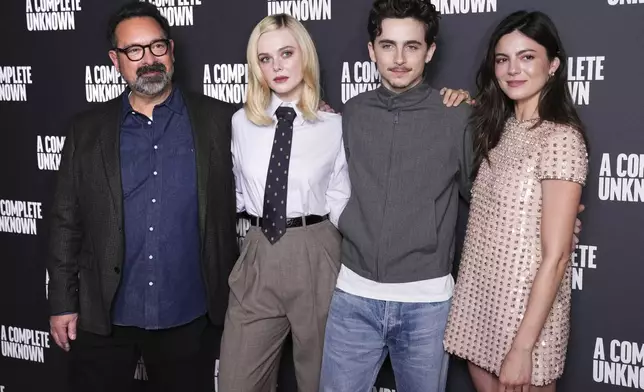 Director James Mangold, from left, Elle Fanning, Timothee Chalamet and Monica Barbaro pose for photographers upon arrival at the photo call for the film 'A Complete Unknown', in London, on Monday, Dec. 16, 2024. (Photo by Scott A Garfitt/Invision/AP)