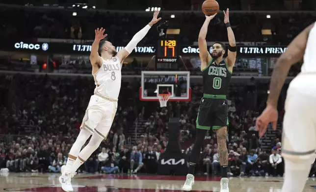 Boston Celtics' Jayson Tatum shoots as Chicago Bulls' Zach LaVine defends during the first half of an NBA basketball game Saturday, Dec. 21, 2024, in Chicago. (AP Photo/Charles Rex Arbogast)