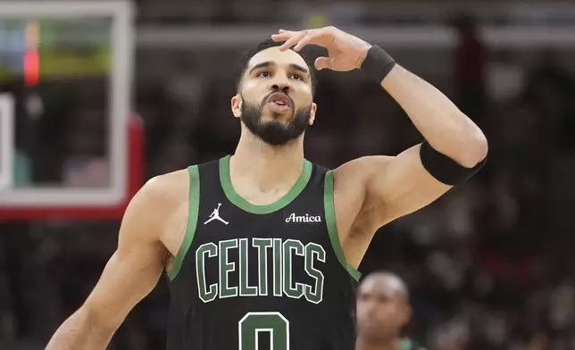 Boston Celtics' Jayson Tatum blows a kiss skyward after scoring a 3-point basket during the second half of an NBA basketball game against the Chicago Bulls on Saturday, Dec. 21, 2024, in Chicago. (AP Photo/Charles Rex Arbogast)